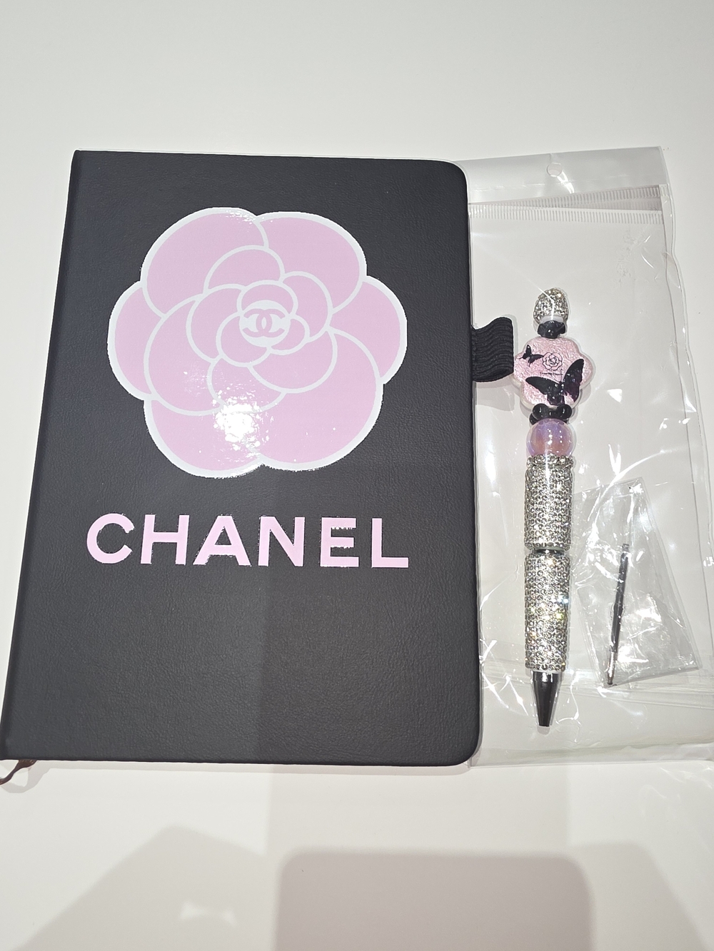 Fashion Inspired Black Notebook with Pink Camellia Logo & Sparkle Pen